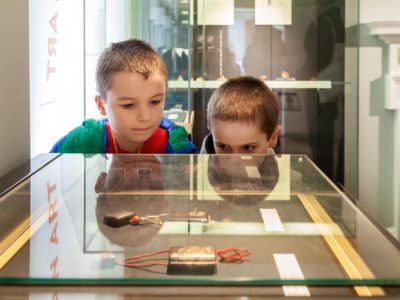 Two children looking into glass case