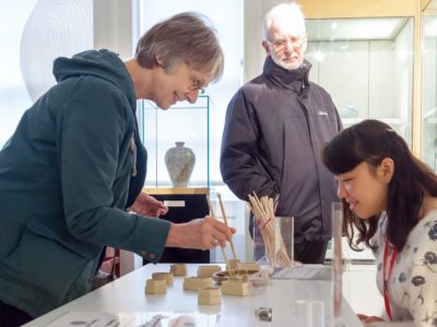 Group of three people working on exhibits