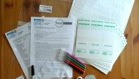 laid out partner pack with paperwork, pest trap kits, pens and other equiptment