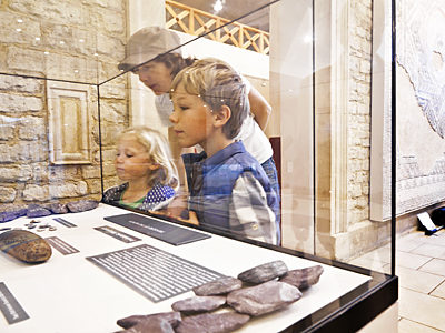 A family look into a museum case