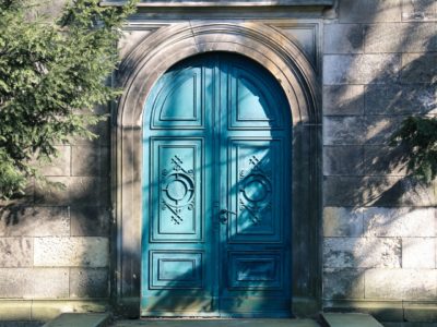 A blue door in an arched doorway.