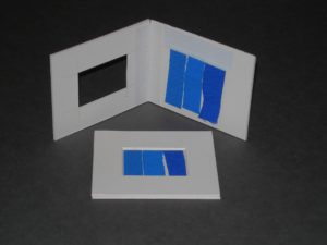 Three blue strips attached to white card frame for measuring light damage