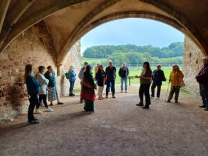 A group pf people under a vaulted ceiling
